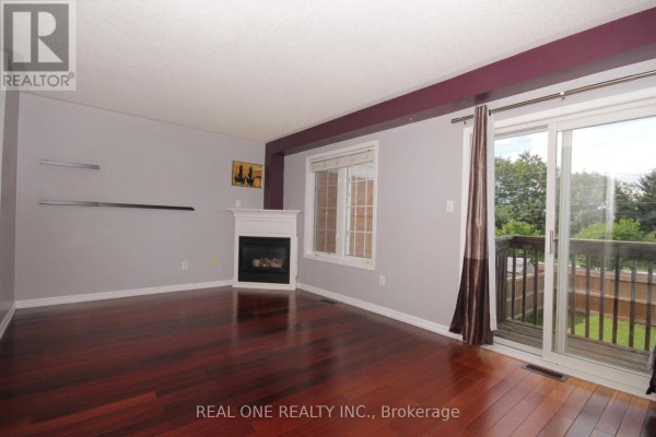 Basement room with furniture, television, windows, and sliding glass door. - 12 Bonello Crescent, Whitby