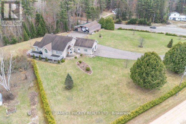 Spacious living area with high ceilings, tile flooring, and staircase. - 12 Boudreau Road, Head, Clara And Maria