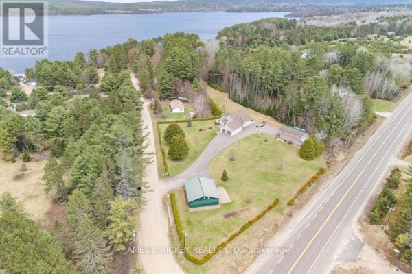 Front entrance with stone steps, double doors, and landscaped yard. - 12 Boudreau Road, Head, Clara And Maria