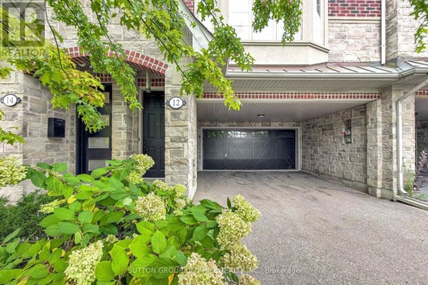 Close-up of townhouse entrance and covered garage at 12 Gala Lane. - 12 Gala Lane, Toronto