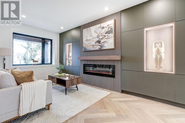 Close-up of the living area with artwork, fireplace, and modern cabinetry - 12 Macdonell Avenue, Toronto