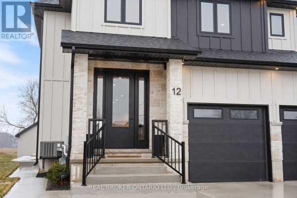 Bright foyer with a view of the front door, light wood flooring, and decorative console table. - 12 Macneil Court, Bayham
