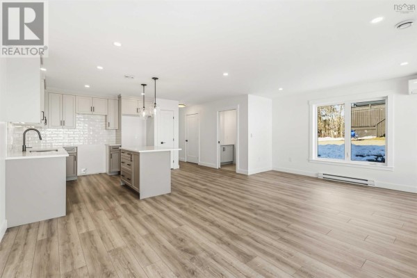 Open living area with light wood flooring and large windows - 12 Nottingham Lane, Enfield