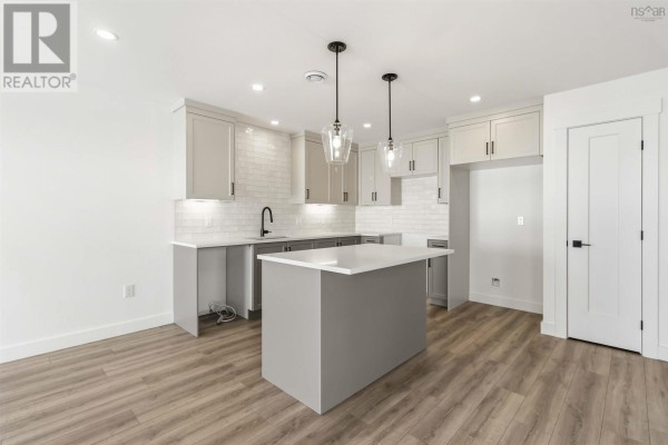 Modern kitchen with gray island, white cabinetry, and pendant lights - 12 Nottingham Lane, Enfield