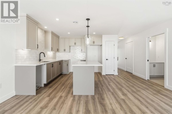 Kitchen view featuring stainless steel appliances and white backsplash - 12 Nottingham Lane, Enfield