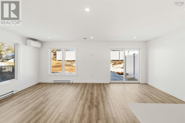 Bright living room with large windows and access to outdoor patio - 12 Nottingham Lane, Enfield