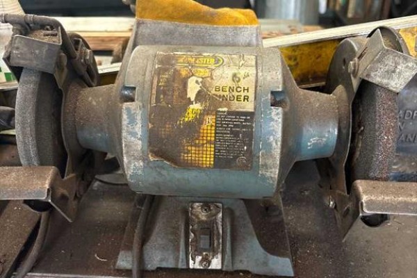 Close-up of a blue bench grinder with two wheels and a yellow guard - 12 Parkland Ave, Rural Ponoka County