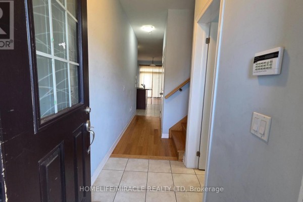 Kitchen showing dark wood cabinets, granite countertops, and white tiled backsplash. - 12 Pearman Crescent, Brampton