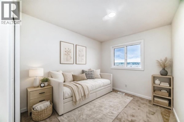 Guest bedroom with a beige daybed, wooden nightstand, and window with a view of a partly cloudy sky. - 12 Savanna Place Ne, Calgary