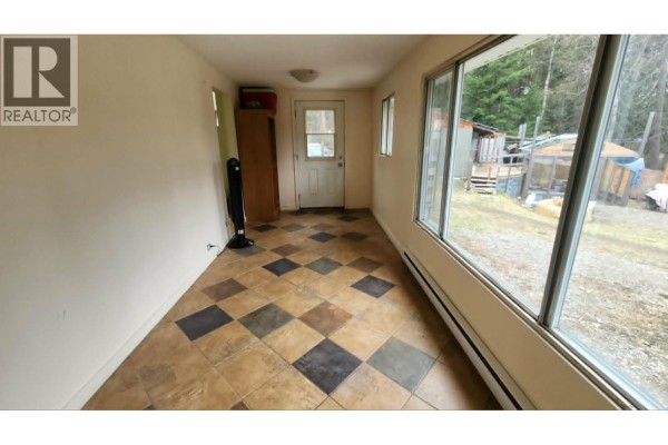 Interior room with a white door, a tall wooden cabinet, and large windows overlooking trees. - 12 Specht Road, Cherryville