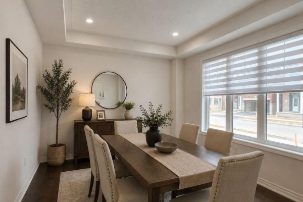 Kitchen with white cabinets, stainless steel appliances including refrigerator and stove, and marble countertops. - 12 Thelma Drive, Whitby