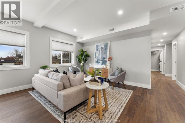 View of the living room looking down a hallway towards interior doors. - 120 Centre Street Unit# 1b, Essex