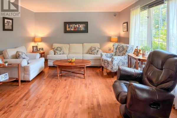 Living room with sofas, armchair, recliner, coffee table, and large window view. - 120 Dawson Heights, Pine Grove