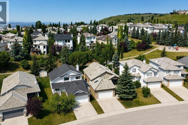 Street view of houses on a hill in a suburban neighborhood. - 120 Gleneagles Terrace, Cochrane