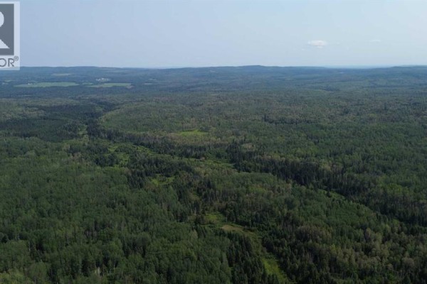 Distant aerial view of extensive forest land with a highway and scattered clearings. - 120 Range Road, Rural Woodlands County