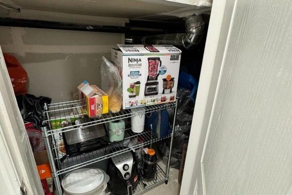 Storage closet with shelving unit containing kitchen appliances and boxes. - 120 Viceroy Crescent, Brampton