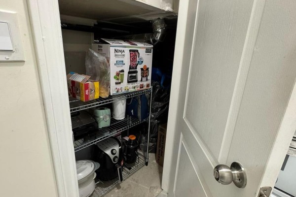 Storage closet with shelving unit containing kitchen appliances and boxes. - 120 Viceroy Crescent, Brampton