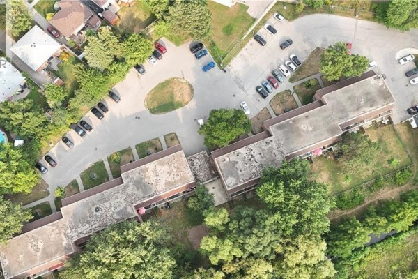 Aerial view of the townhouse complex with multiple units and surrounding trees. - 1200 Courtland Avenue Unit# 3, Kitchener