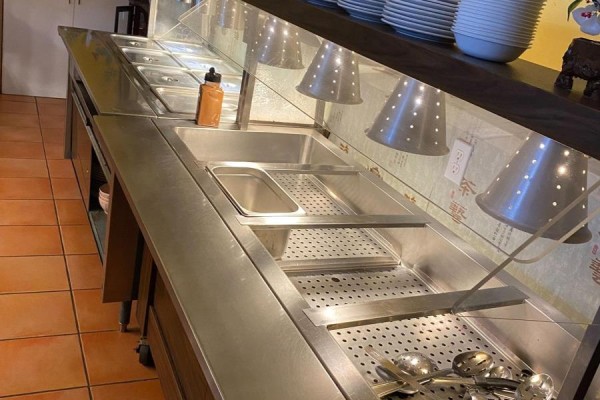 Close-up of buffet serving station with heating lamps and stainless steel. - 1200 Lansdowne Street W, Peterborough