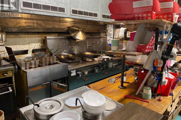 Commercial kitchen with stainless steel range, woks, and deep fryers. - 1200 Lansdowne Street W, Peterborough