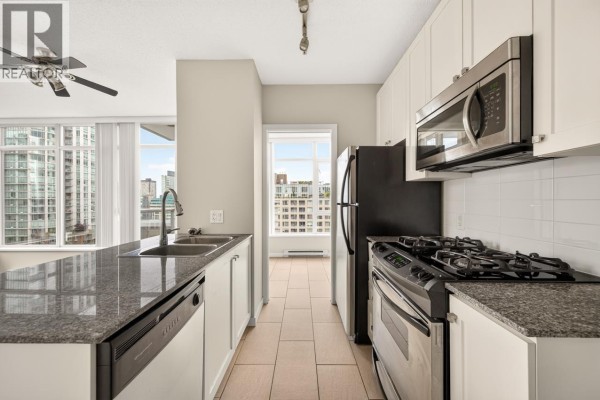 Floor plan of a two-bedroom apartment with living/dining room, kitchen, den, balcony, and two bathrooms. - 1201 480 Robson Street, Vancouver