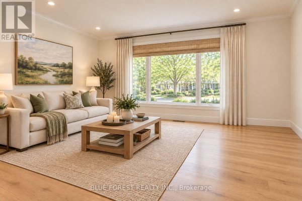 Staged living room with neutral furniture, large window, and landscape artwork. - 1201 Patann Drive N, London East