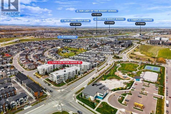 Aerial view showing apartment building location with nearby amenities and schools. - 1202, 220 Seton Grove Se, Calgary