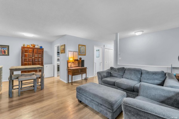 Kitchen with dark cabinets, built-in appliances, and light wood flooring - 1202 10620 150 Street, Surrey