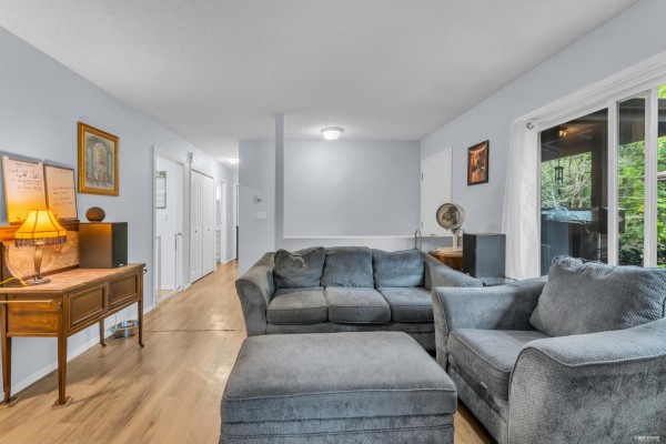 Colorful room with purple walls, plants, and wooden furniture - 1202 10620 150 Street, Surrey
