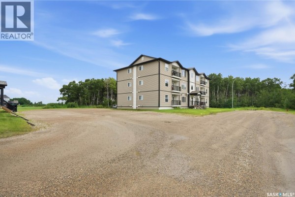 Wide view of Rocanville showing multi-family buildings and surrounding snowy landscape. - 1202&1212 Dauncey Drive, Rocanville