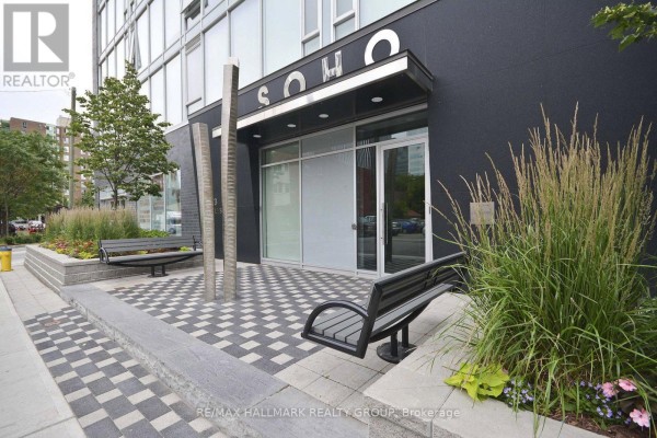 Building entrance with SOHO sign, glass doors, benches, and landscaping. - 1203 - 300 Lisgar Street, Ottawa