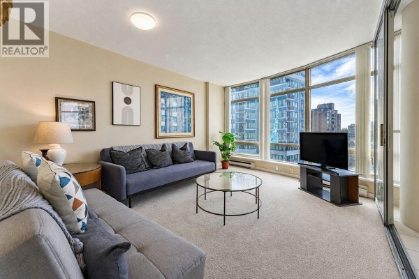 A hallway with wood-paneled walls, a grey carpet, a console table, and large glass windows. - 1203 1288 Alberni Street, Vancouver