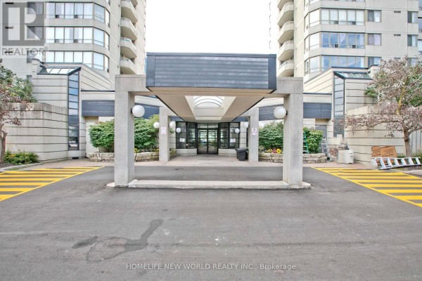 Entrance to the apartment building with a covered walkway and modern architectural features. - 1204 - 160 Alton Towers Circle, Toronto