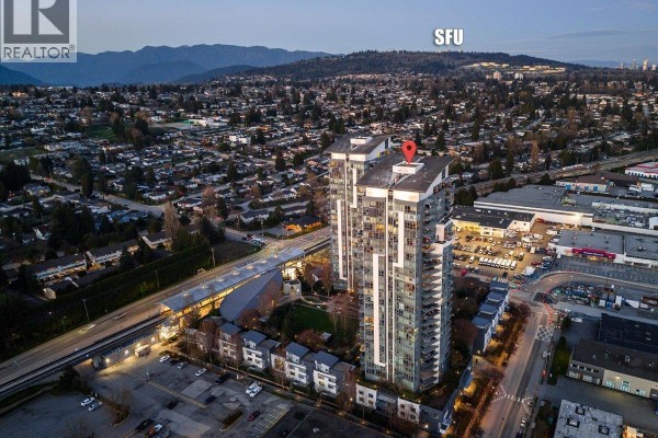 Aerial view of twin apartment towers with surrounding neighborhood and distant mountains. - 1204 5611 Goring Street, Burnaby