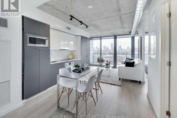 Dining area with glass table and white chairs, adjacent to kitchen and living room. - 1205 - 170 Bayview Avenue, Toronto