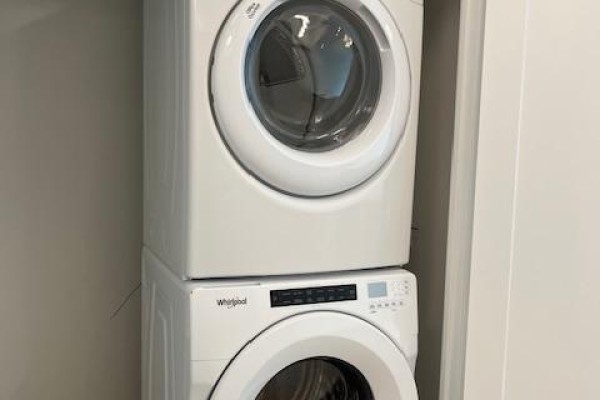 Stacked white Whirlpool washer and dryer in a closet. - 1205 - 310 Tweedsmuir Avenue, Toronto