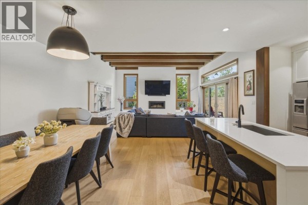 Open concept living and dining area with a fireplace and island. - 1205 Mount Fee Road, Whistler