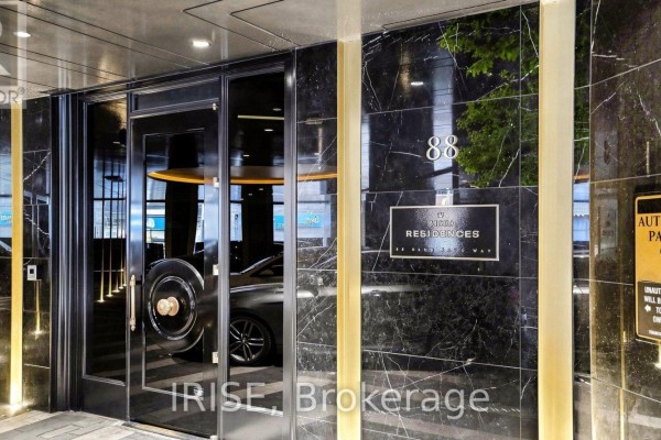 The entrance to 88 Blue Jays Way residences with black marble exterior and glass doors. - 1207 - 88 Blue Jays Way, Toronto