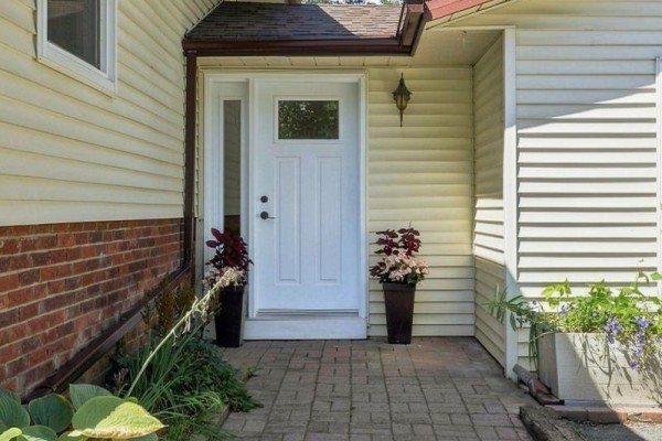White kitchen with stainless steel appliances, wood countertops, and laminate flooring. - 1207 County Rd 9 Street, Greater Napanee