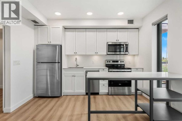 Living room - 1208, 123 4 Street Ne, Calgary, AB T2E8K3 Photo 4