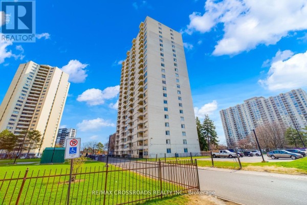 Tall apartment buildings with balconies and parking lot - 1208 - 340 Dixon Road Toronto