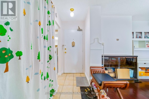 Hallway with tree shower curtain, bench, and shelving - 1208 - 340 Dixon Road Toronto