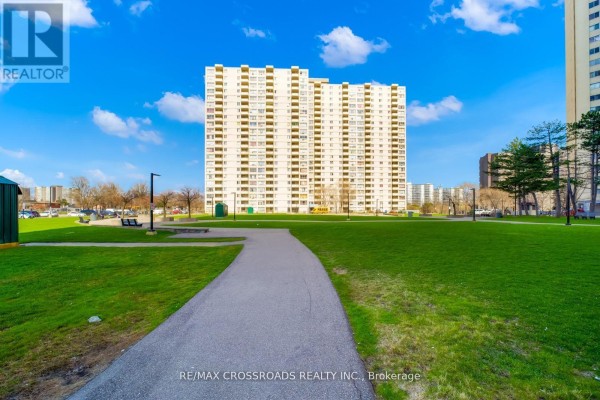Apartment building and park with pathway and benches - 1208 - 340 Dixon Road Toronto