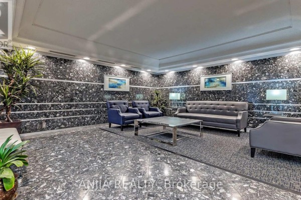 Lobby featuring dark marble flooring, modern seating, and decorative plants. - 1208 - 4727 Sheppard Avenue E, Toronto