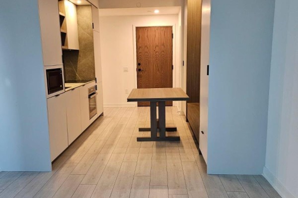 View of the dining area and kitchen from the entrance door of the apartment. - 1208 - 55 Charles Street E, Toronto