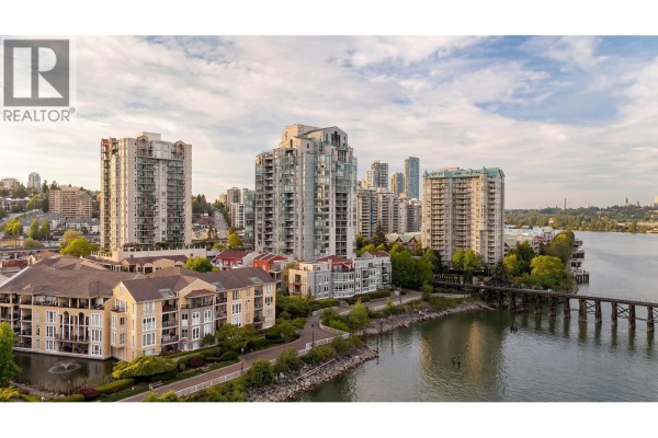 Aerial view of apartment buildings, townhouses, and the Fraser River waterfront. - 1208 10 Laguna Court, New Westminster