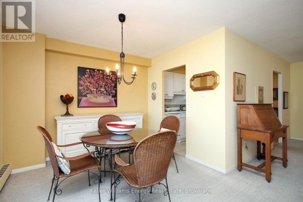 Dining area with a round table, wicker chairs, and a sliding glass door. - 1209 - 1210 Radom Street, Pickering