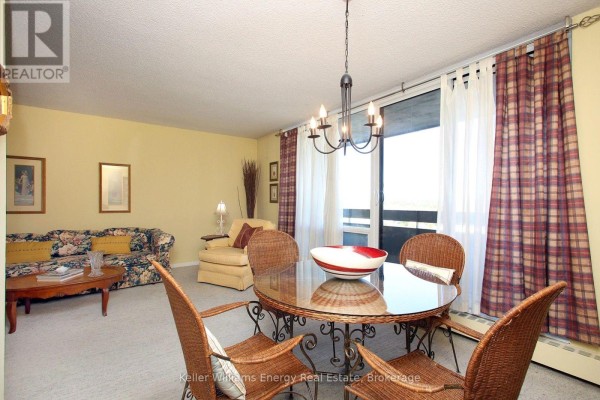 Dining area with a round table, wicker chairs, buffet, and an open doorway to the kitchen. - 1209 - 1210 Radom Street, Pickering