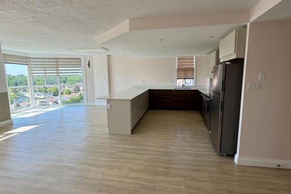 Open-concept kitchen and living space with modern cabinetry and stainless steel appliances. - 1209 - 2760 Carousel Crescent, Ottawa
