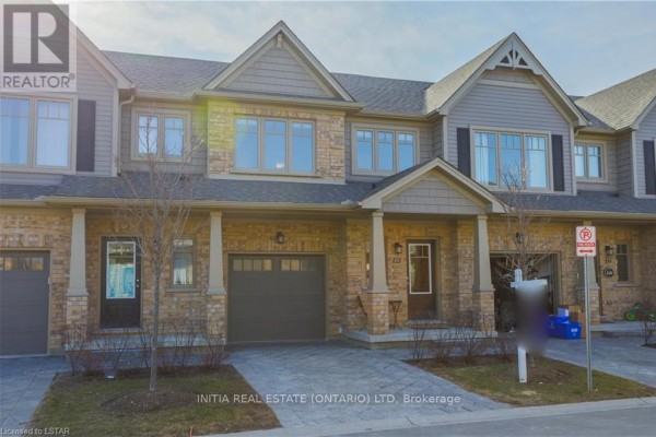 Front exterior view of townhouses with garage doors and entryways. - 121 - 1924 Cedarhollow Boulevard, London North